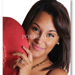 young woman peeking from behind a large hat she's holding.©Created Portraits Photography